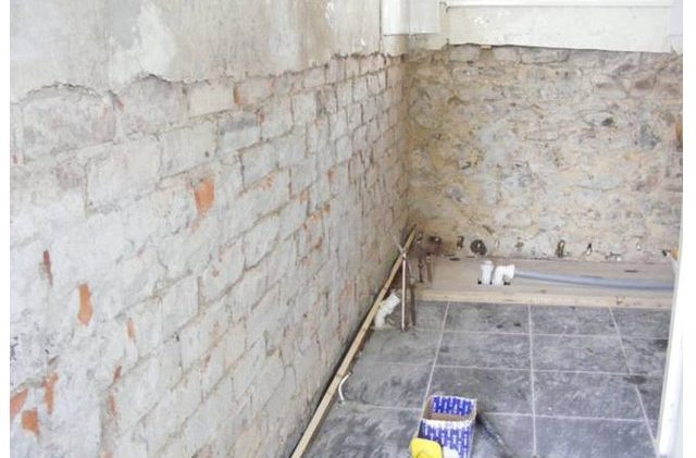 Walls that have been stripped back to the brick as there was an outbreak of rising damp.